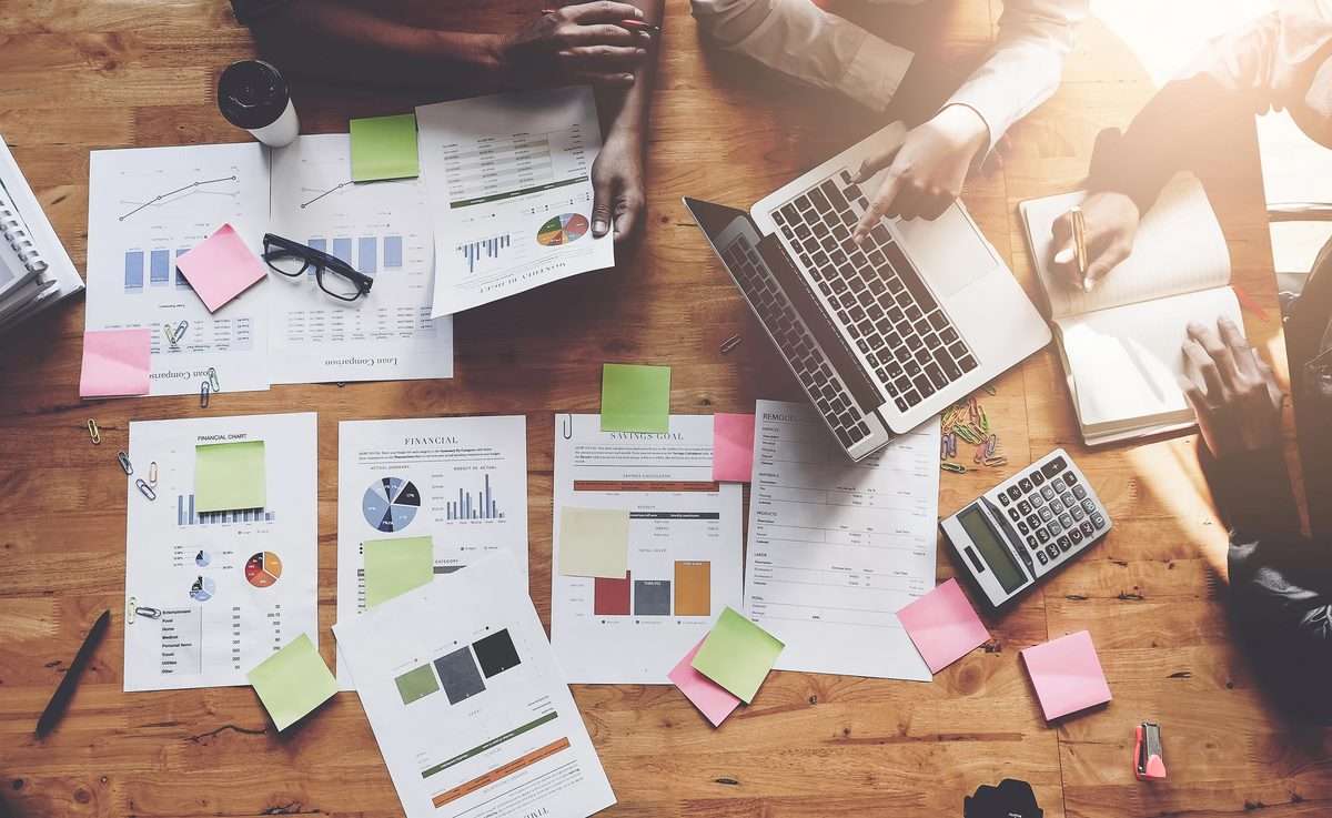 Financial reports and a laptop on a desk, illustrative photography